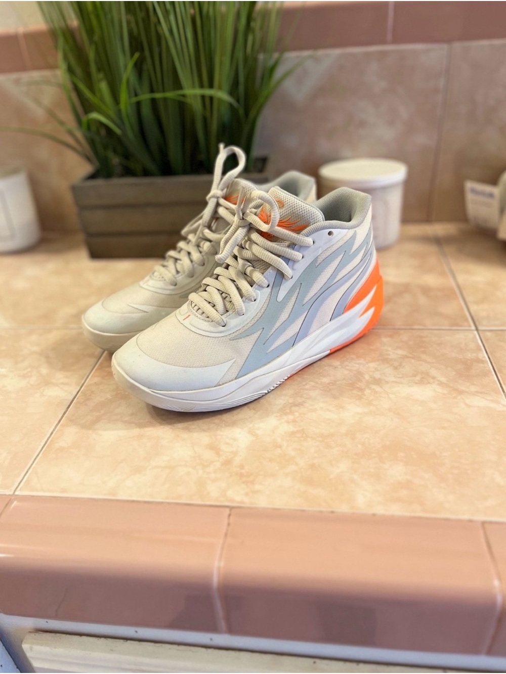 Lamelo’s grey, white and orange puma shoes